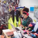 mechanic-using-laptop-while-listening-music_1170-2363