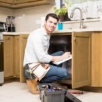 portrait-attractive-hispanic-handyman-writing-work-estimate-before-fixing-kitchen-sink_662251-2690