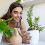 woman-caring-plants-steam-aroma-oil-diffuser-table-home-steam-from-humidifier-humidification-air-apartment-period-selfisolation-due-coronavirus-pandemic_657921-1385