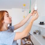 woman-unscrew-light-bulb_1153-3634