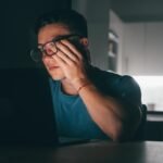 one-young-sick-tired-man-feeling-bad-touching-his-eyes-face-night-after-work-teenager-male-with-head-ache-working_516988-2821