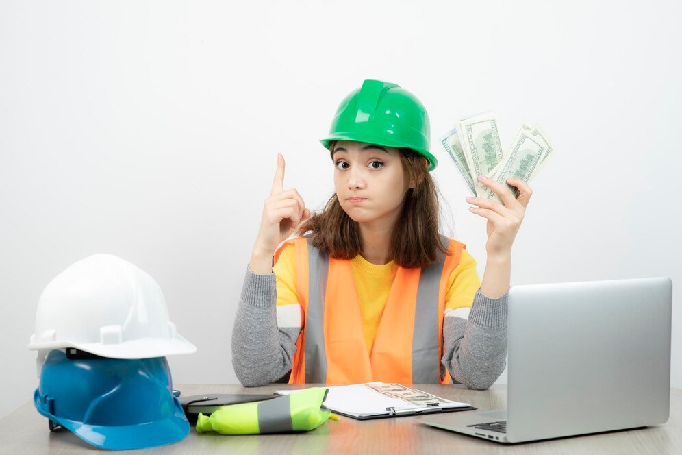 worker-female-orange-vest-green-helmet-sitting-desk-high-quality-photo_2831-9719