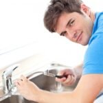 young-man-repairing-kitchen-sink_13339-106353